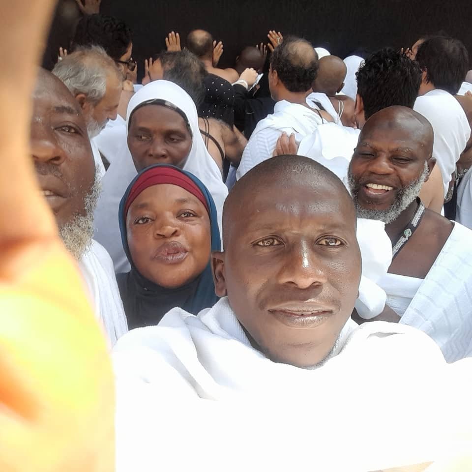 Pilgrims praying at the Sacred Kiswah of the Holy Kaaba